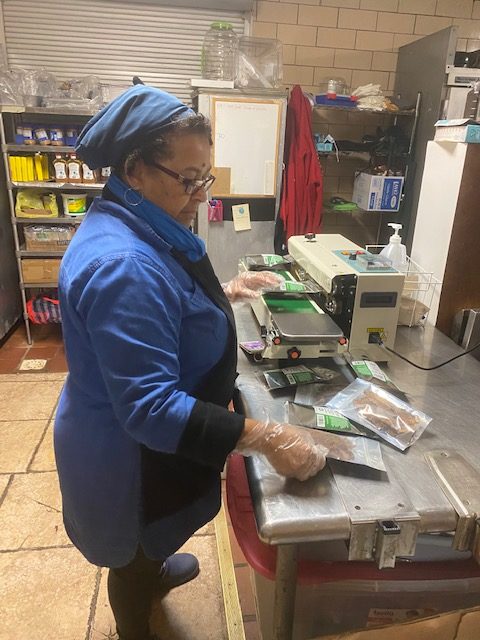 Lady packing food items in plastic bag in a kitchen area