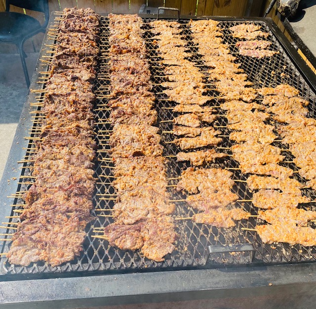 Assorted pieces of meat grilling on a grill, creating delicious smoky flavors